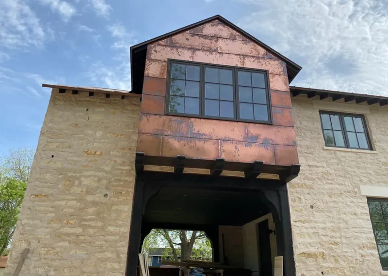 Copper metal panel facade on a stone building for Roof Repair in Belle Plaine